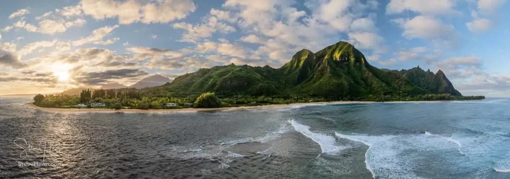 Aerial panoramic image off the coast over Tunnels beach on Hawaiian island of Kauai with Na Pali mountains behind. Prints available here