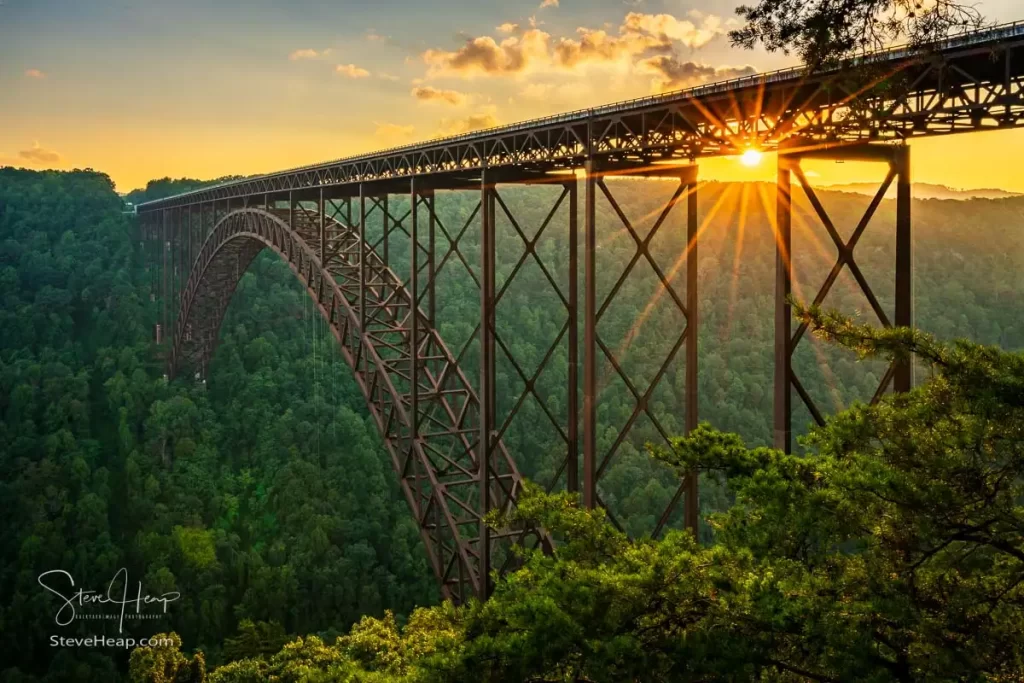 Setting sun behind the girders of the high arched New River Gorge bridge in West Virginia. Prints available in my online store