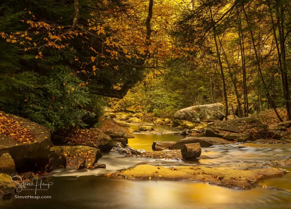 View down the river below the waterfalls with blurred motion on Deckers Creek running by Route 7 near Masontown in Preston County West Virginia