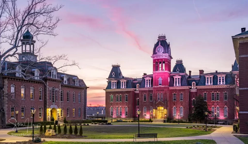 Dramatic image of Woodburn Hall at West Virginia University or WVU in Morgantown WV as the sun sets behind the illuminated historic building