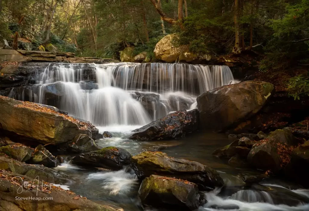 Cascade of waterfall during autumn with blurred motion on Deckers Creek running by Route 7 near Masontown in Preston County West Virginia