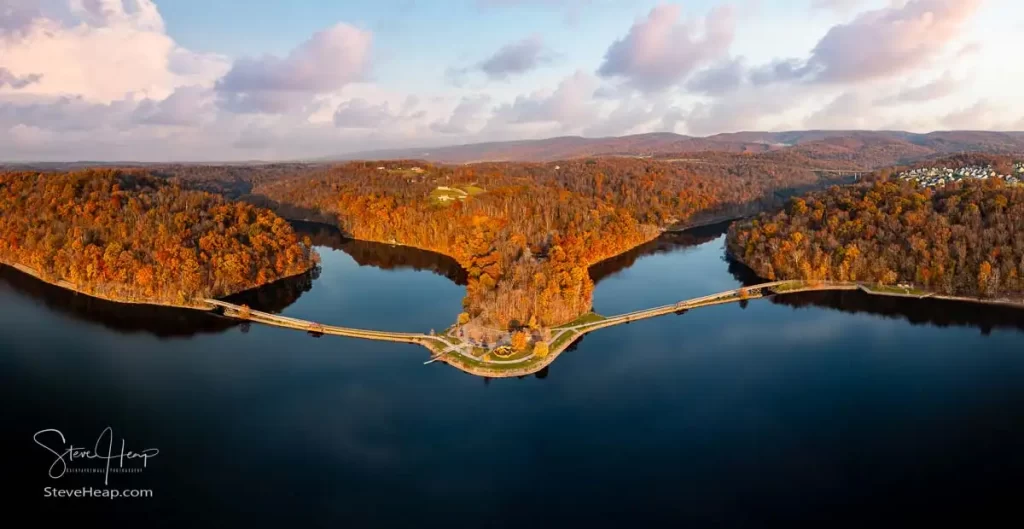 Sun setting casts warm light on the park at Cheat Lake near Morgantown West Virginia on a beautiful calm autumn day