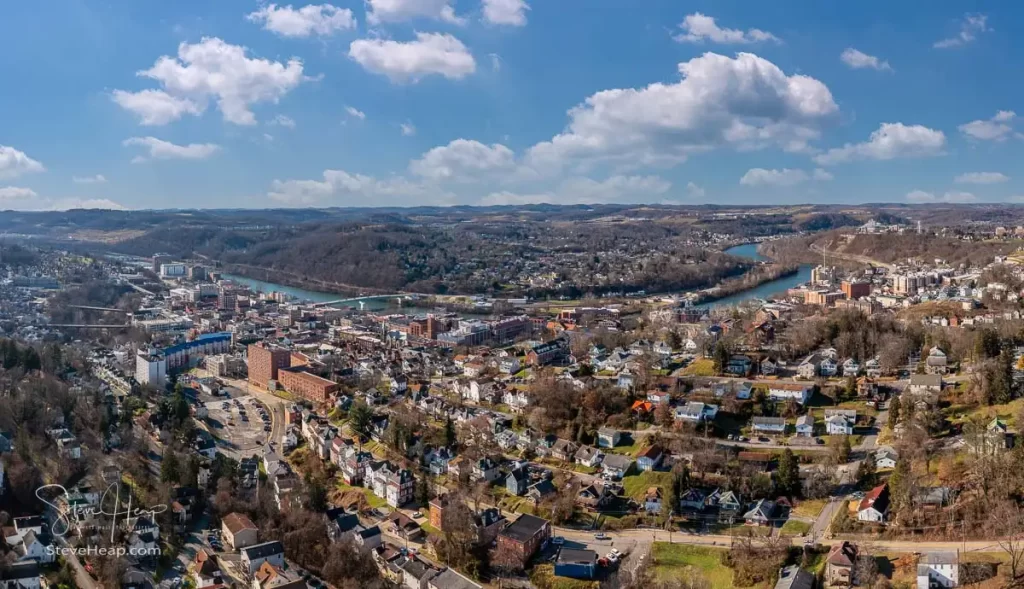 Aerial drone panoramic shot of the downtown campus of WVU in Morgantown West Virginia showing the river in the distance