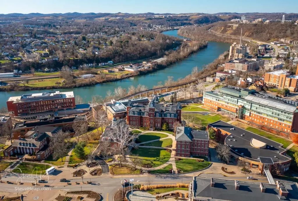 Aerial drone panoramic shot of the downtown campus of WVU in Morgantown West Virginia showing the river in the distance