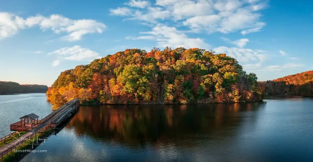 Warm light on the park at Cheat Lake near Morgantown West Virginia on a beautiful calm autumn evening taken from a drone above the water