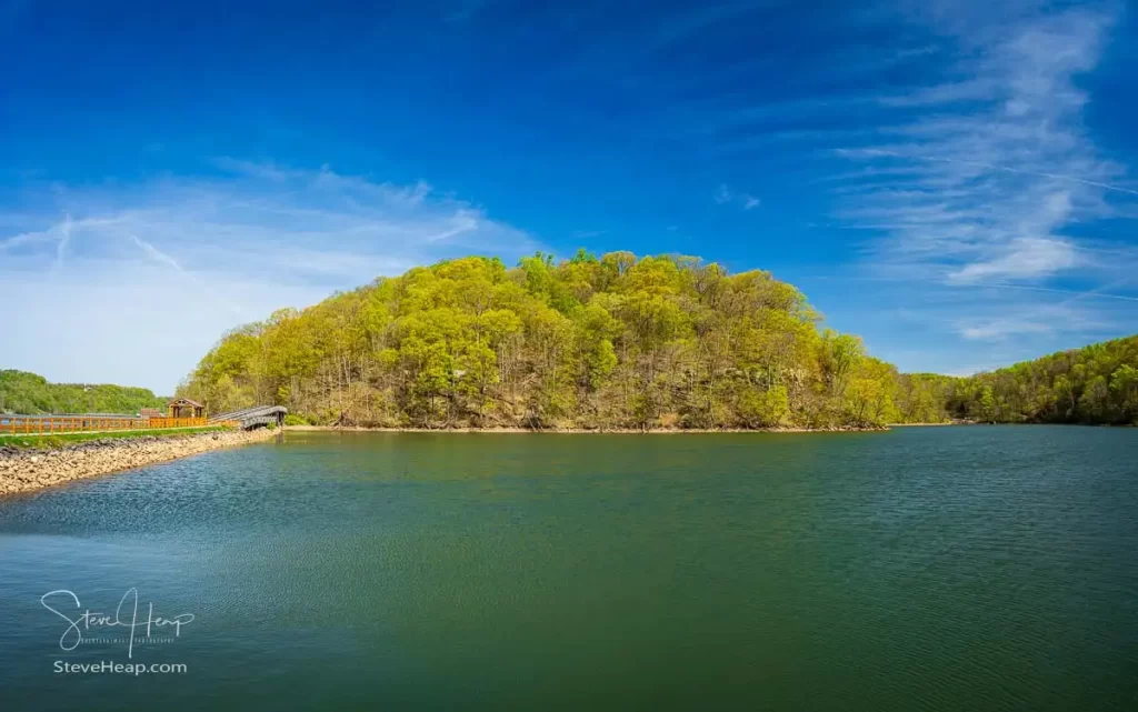 Warm light on the park at Cheat Lake near Morgantown West Virginia on a beautiful calm spring morning as the new leaves start to open on the trees