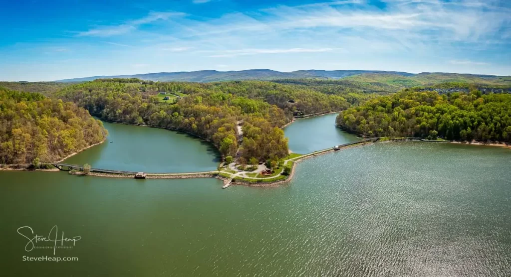 Aerial view as sun casts warm light on the park at Cheat Lake near Morgantown West Virginia on a beautiful calm spring morning