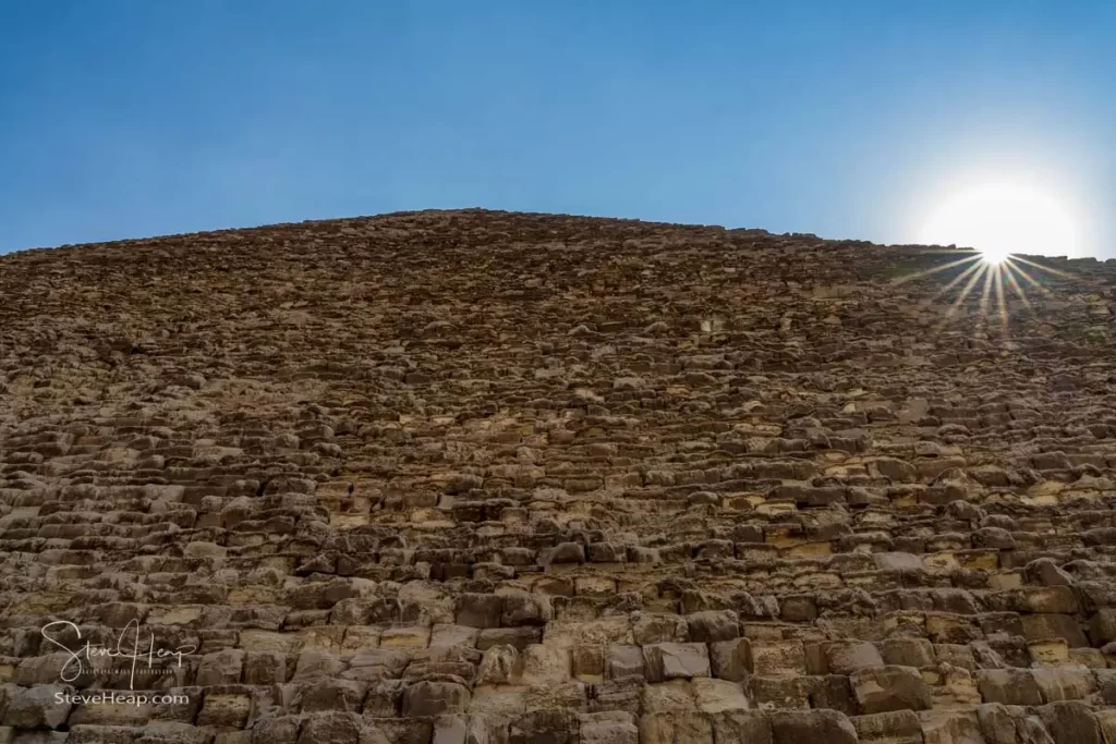 The sun peeks over the Great Pyramid of Giza